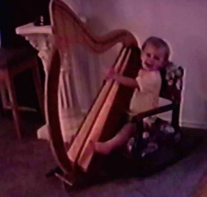 Grace at the harp as a young child